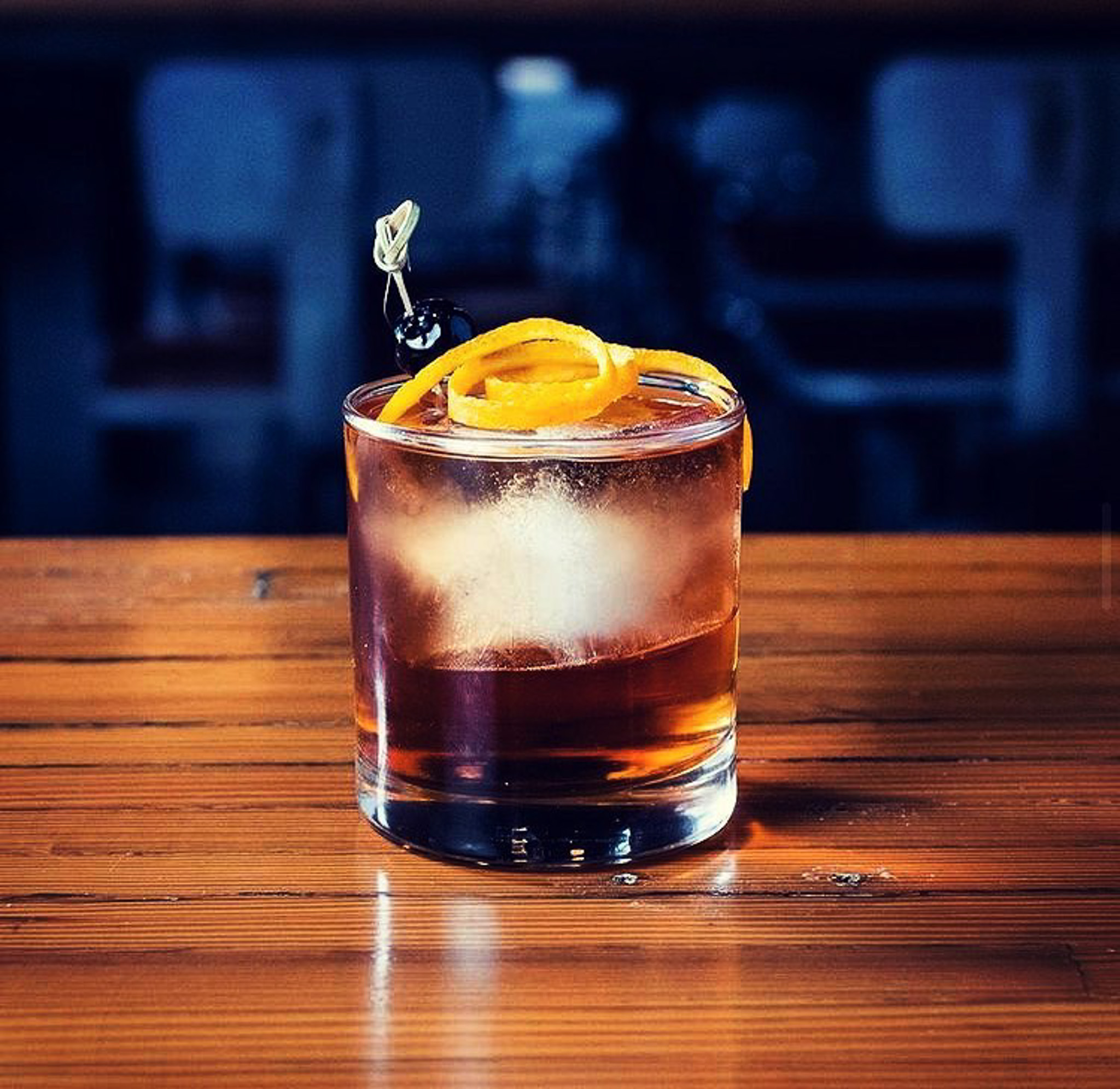 A cocktail with a lemon slice on top