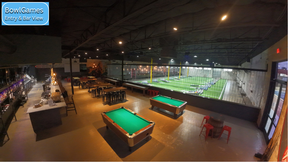 The interior of BowlGames in Dallas, showing the pintoss area and bar area including the pool tables.