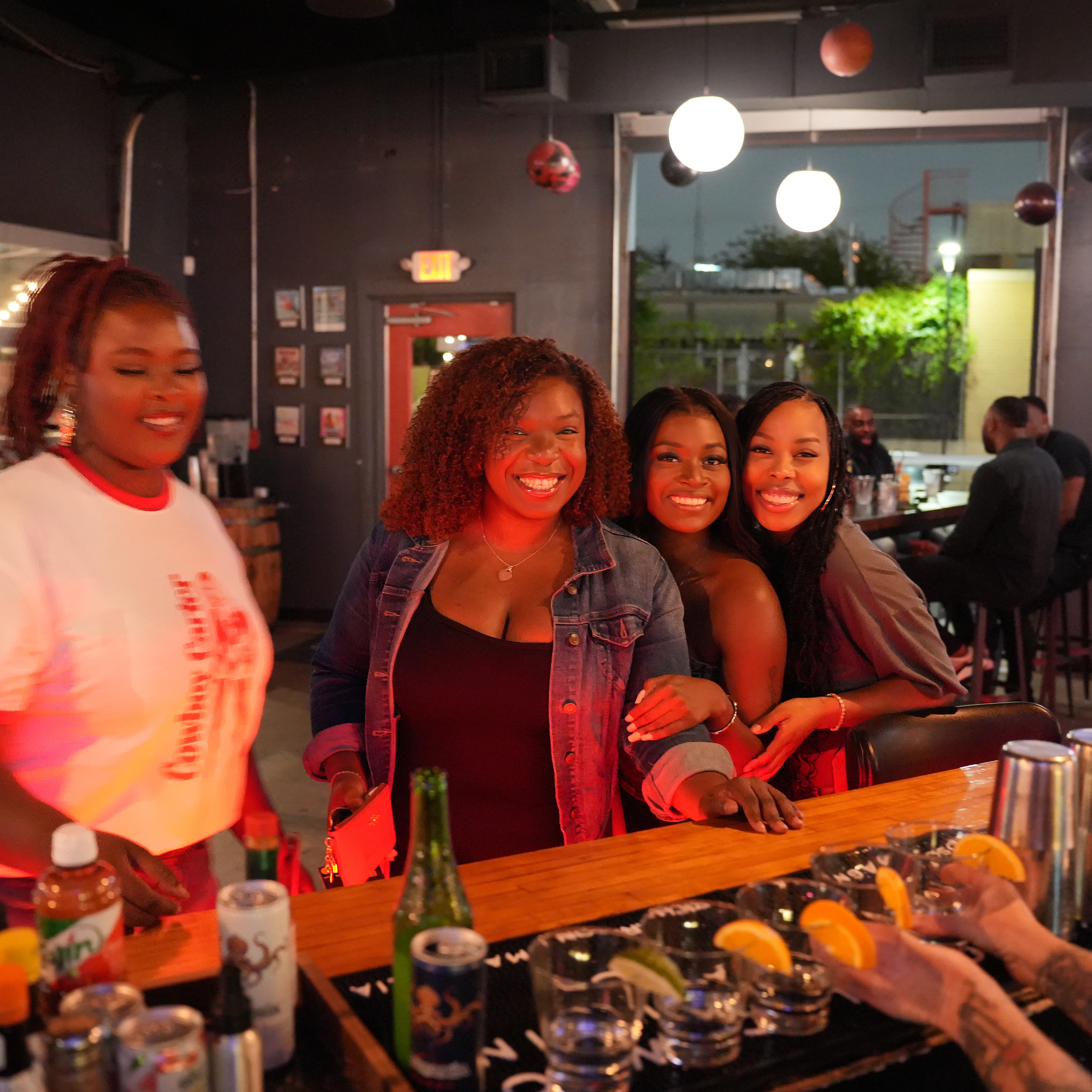 Women smiling and the bar at Bowlounge in Dallas, TX