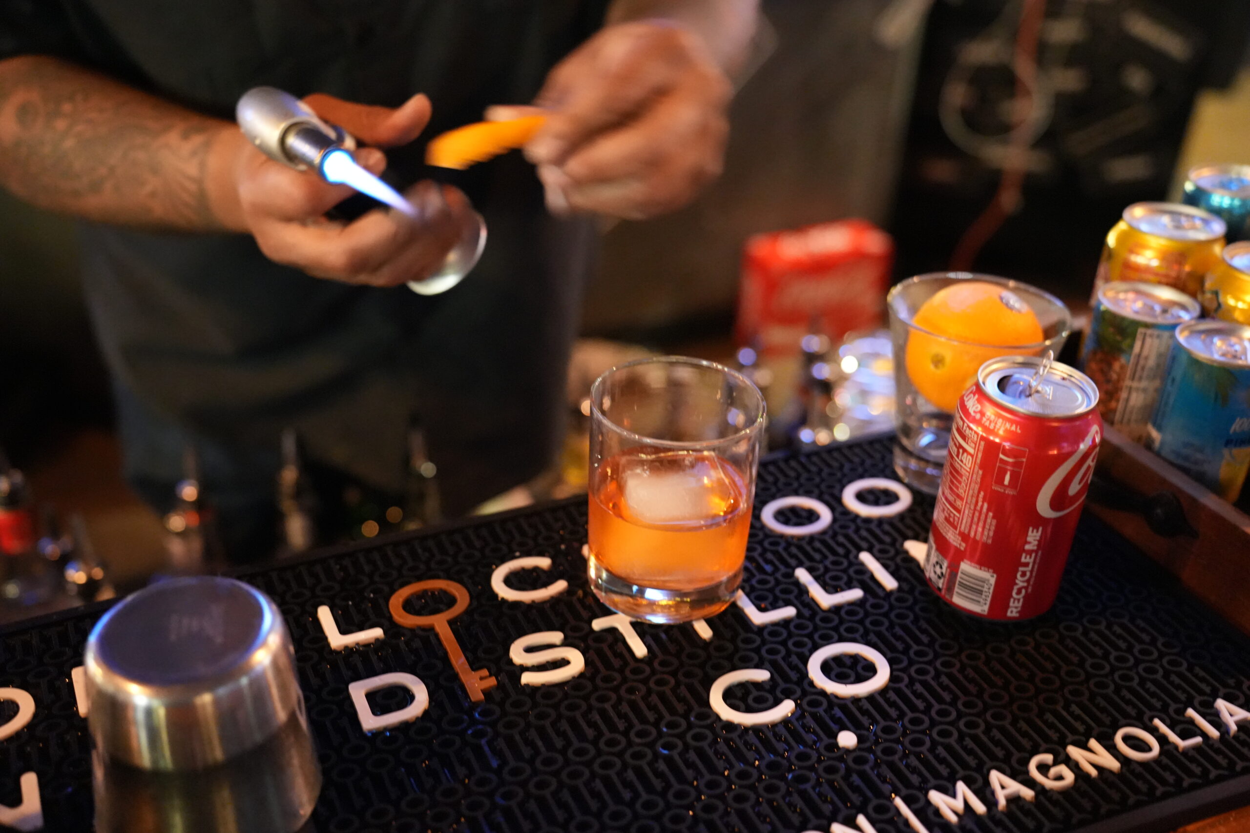 A bartender making a cocktail at the bar at Bowlounge.