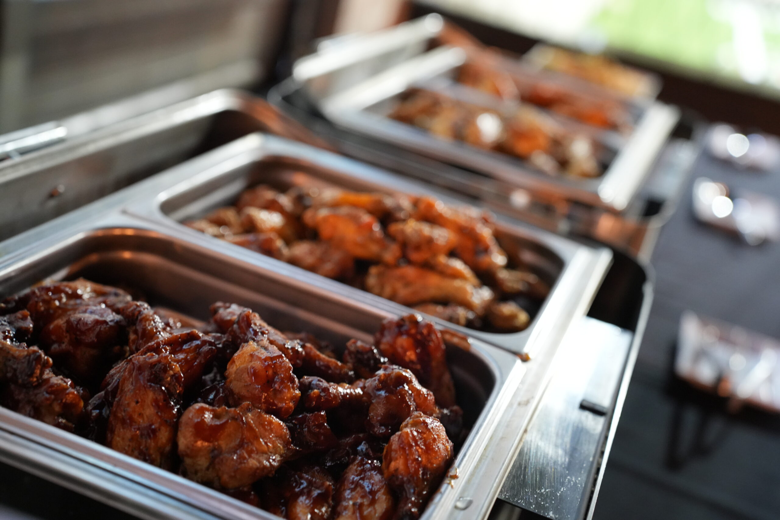 Catered food for a private event at Bowlounge in Dallas Texas, including trays of hot wings.